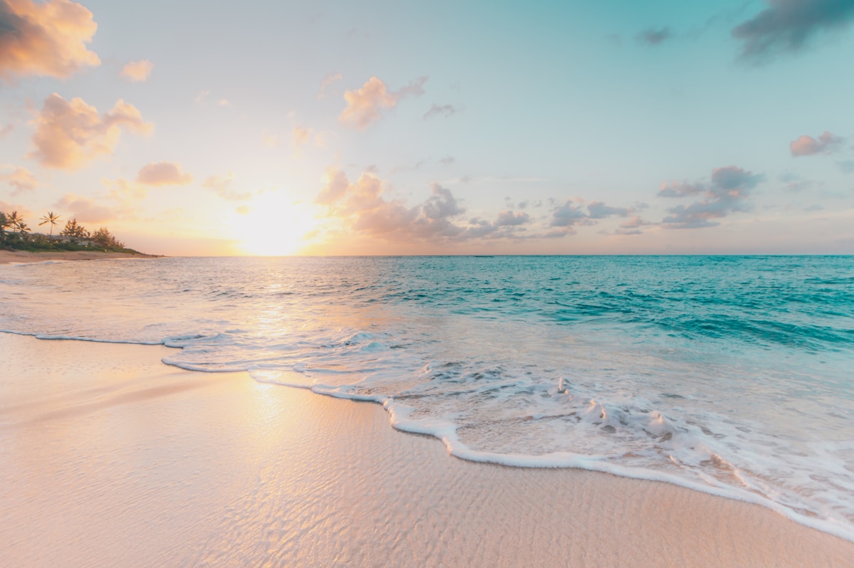 Beach sunset with turquoise water and white sand